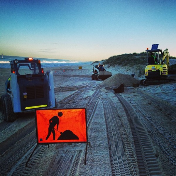 Early Morning drainage works on scarborough beach in perth - part of the tonca earthmoving group of contractors - skidsteer loader bobcat toyota excavator excavation tonka